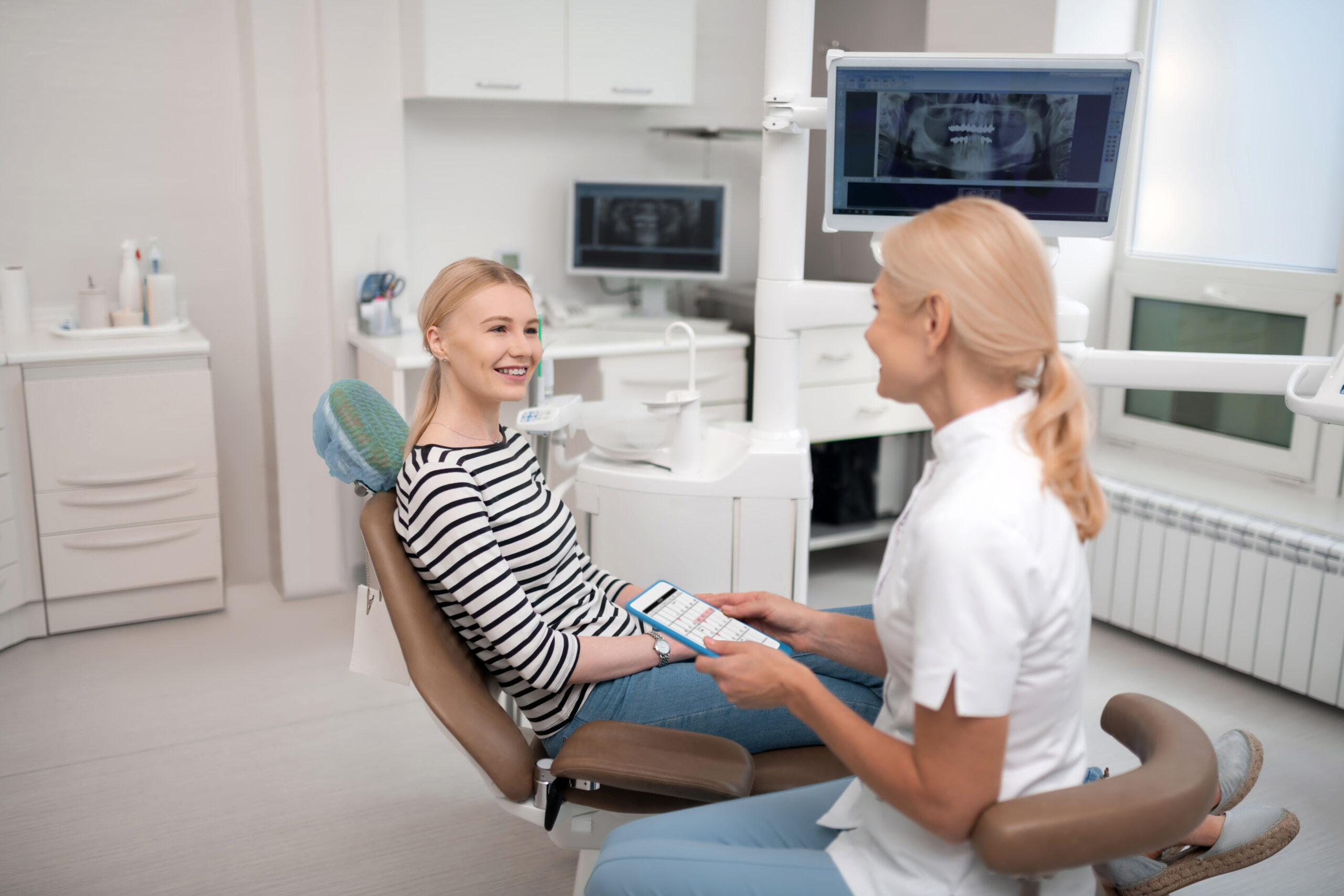 dentist consulting her patient about future appointments