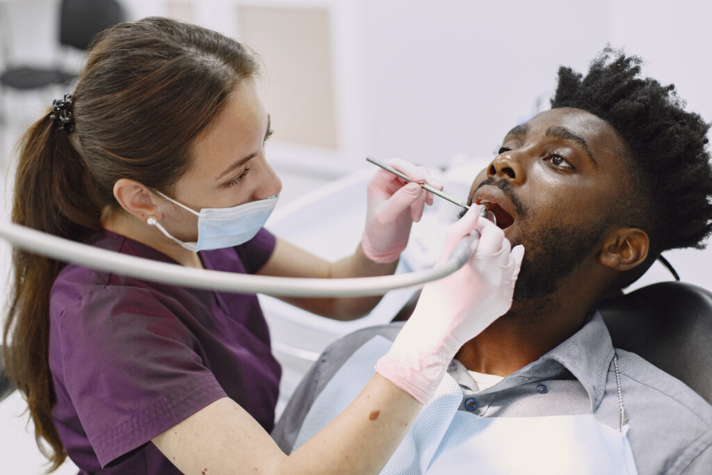 african patient in dentistry sitting in dental chair