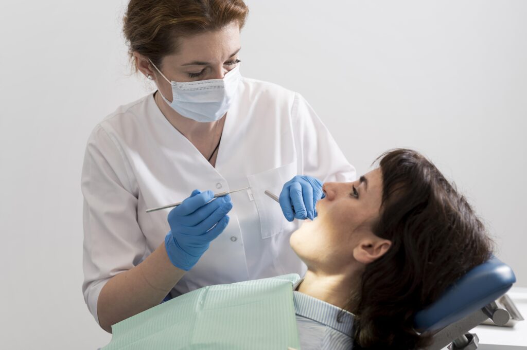 young female patient having dental procedure orthodontist