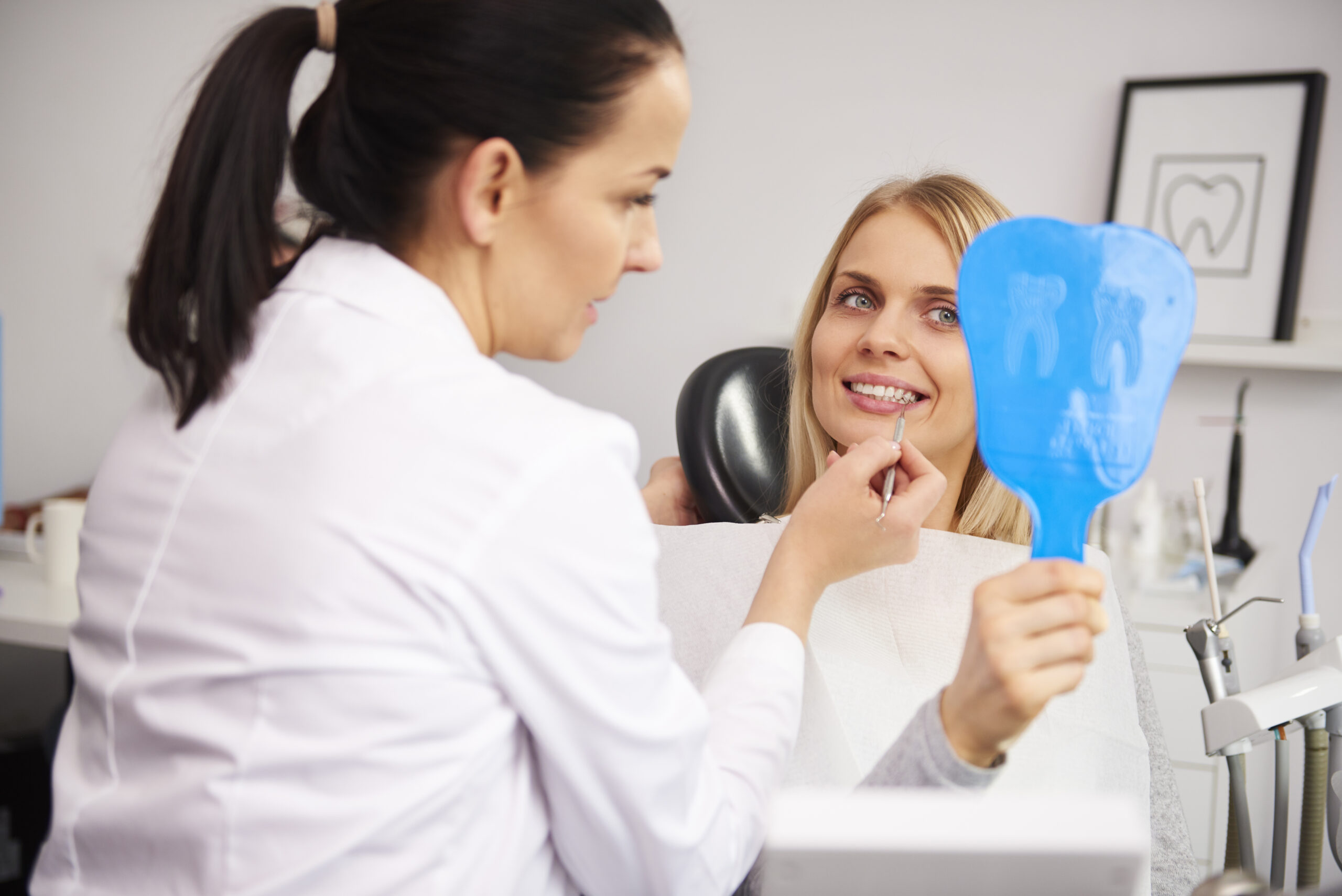 stomatologist checking the woman's teeth during dental checkup